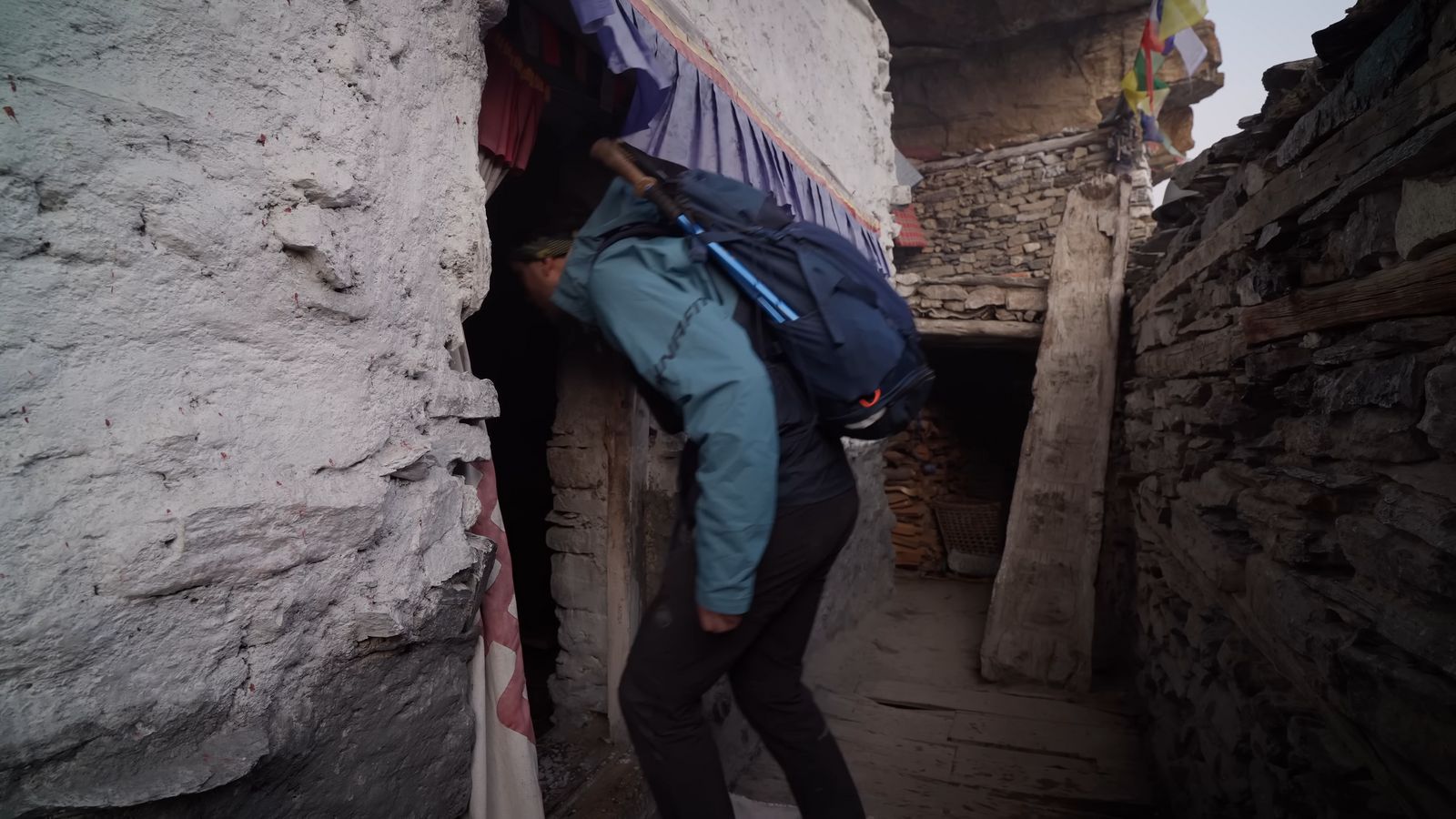 a person with a backpack climbing up a hill