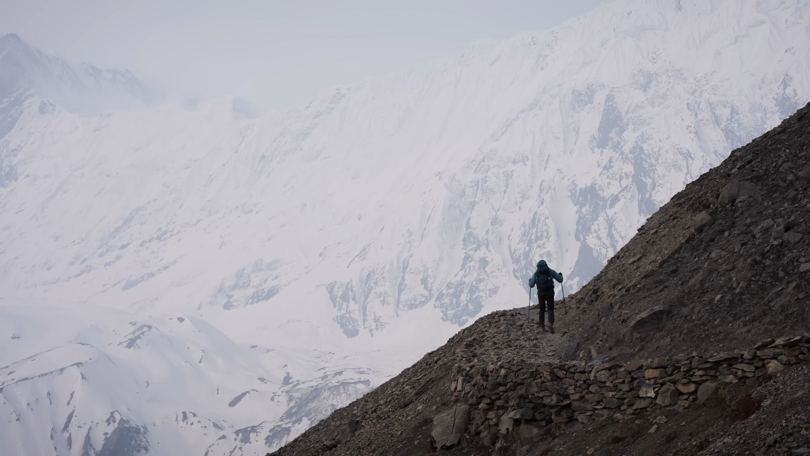 a person standing on top of a rocky mountain