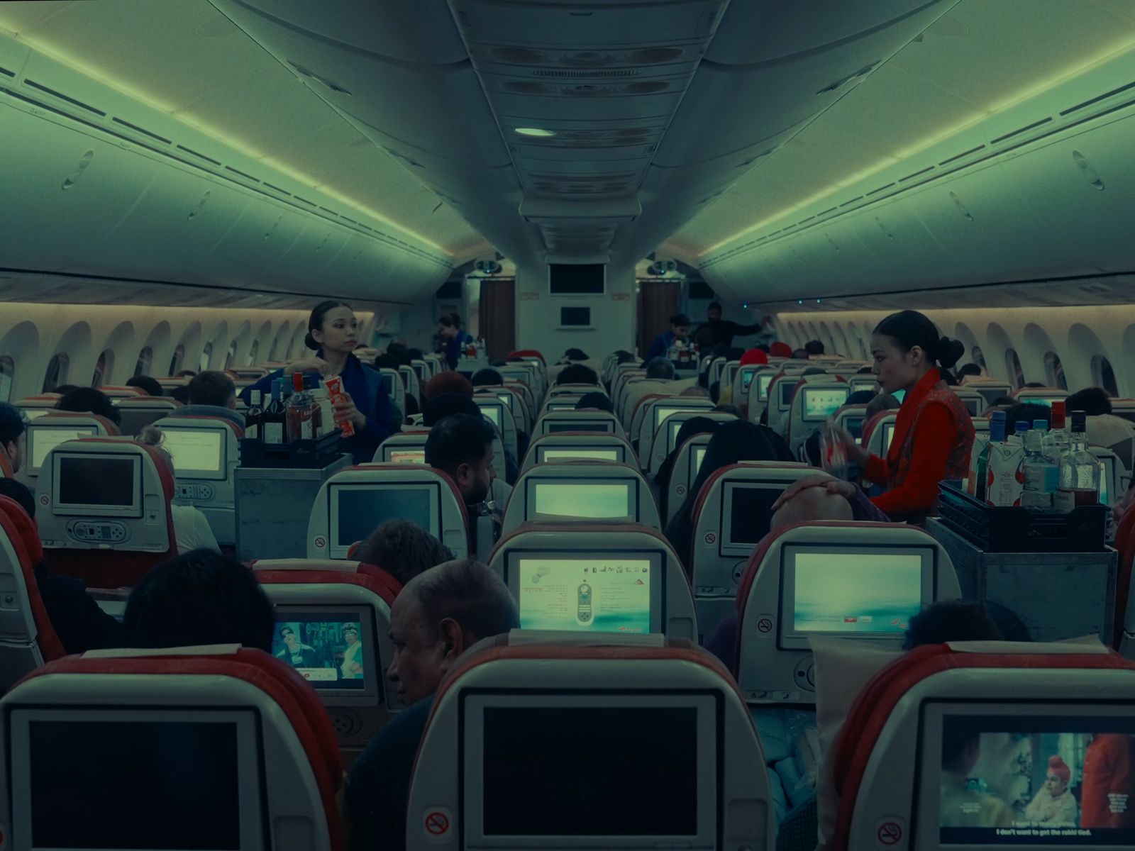 a group of people sitting on seats in an airplane