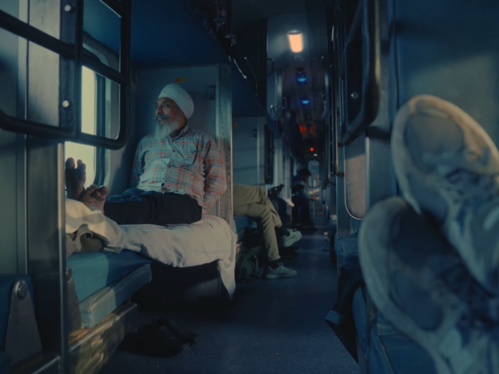 a man sitting on a bed inside of a train