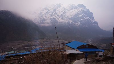 a view of a mountain with a blue roof