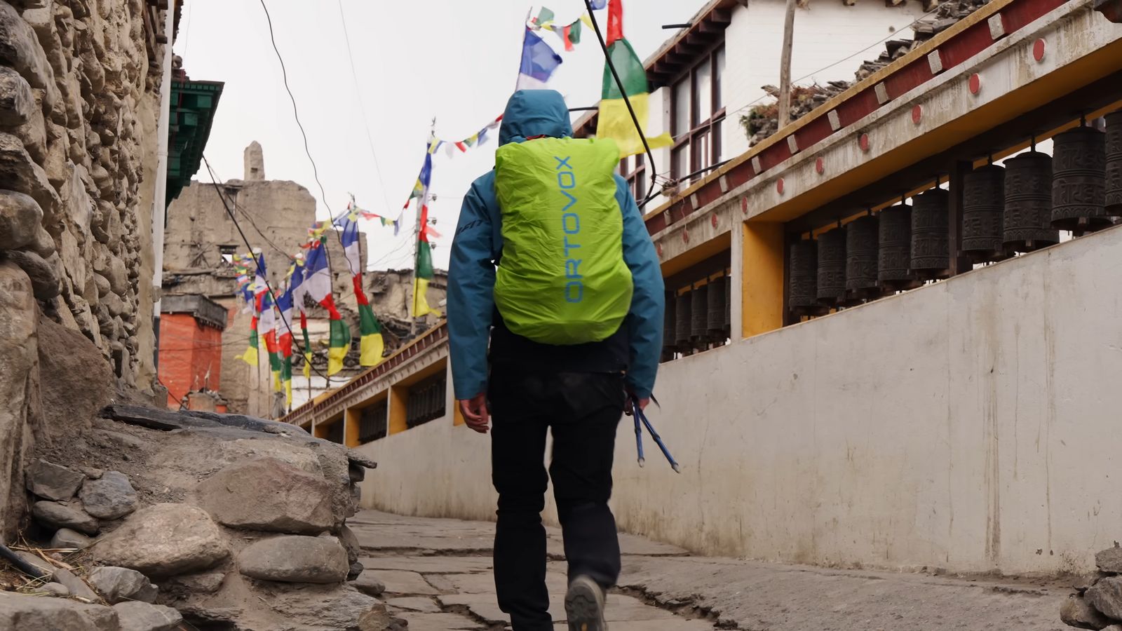 a man with a backpack walking down a street