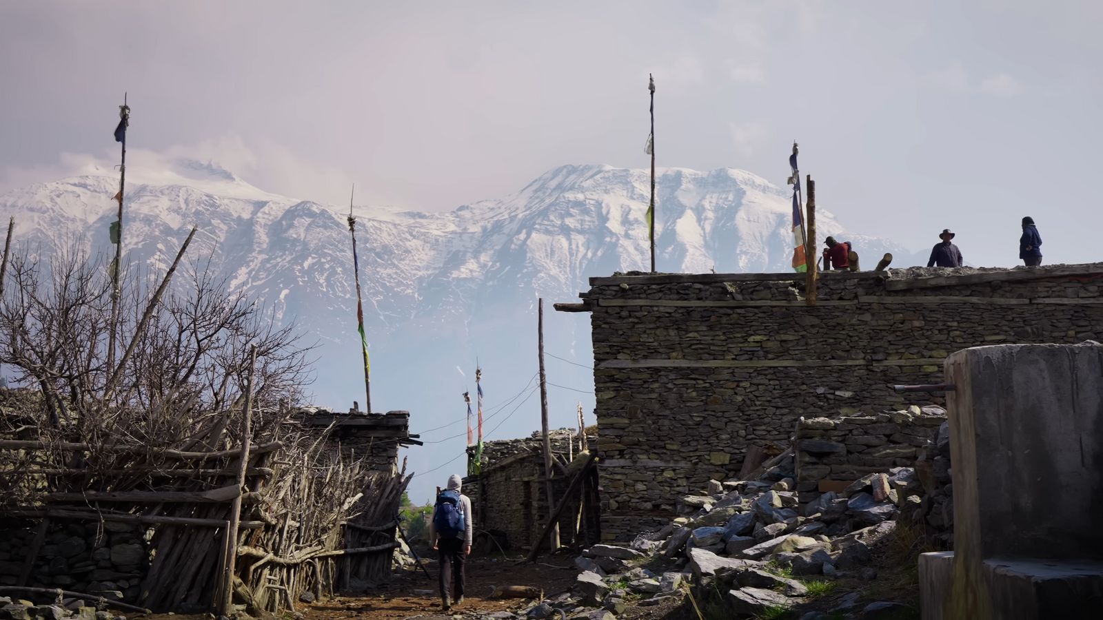 a group of people standing on top of a stone building