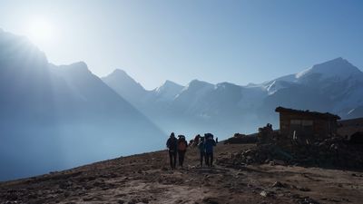 a group of people standing on top of a mountain