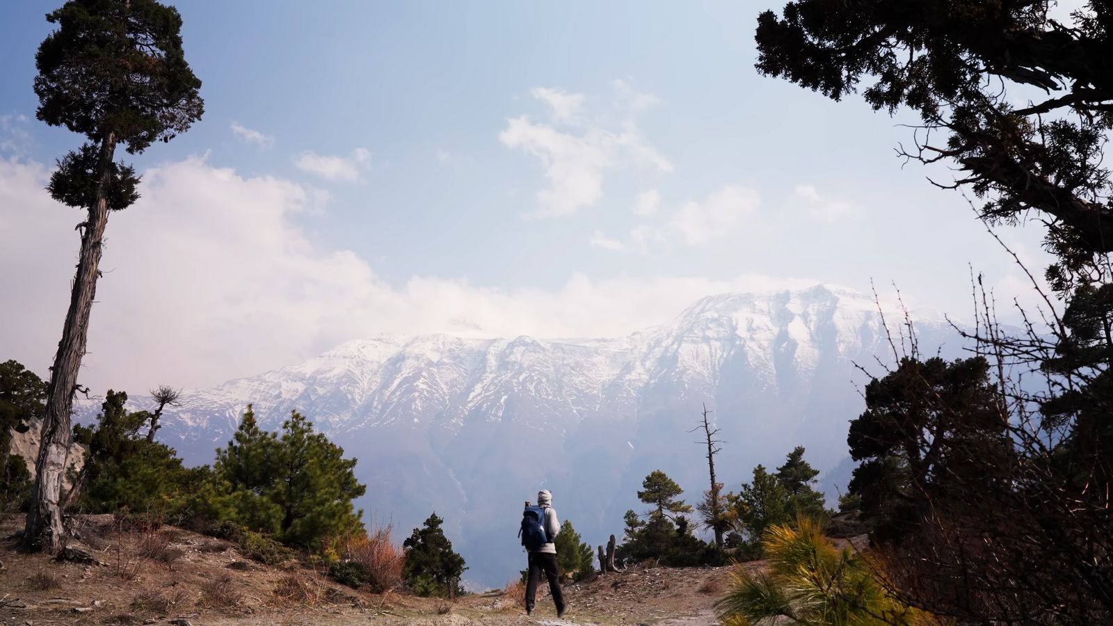 a couple of people standing on top of a mountain