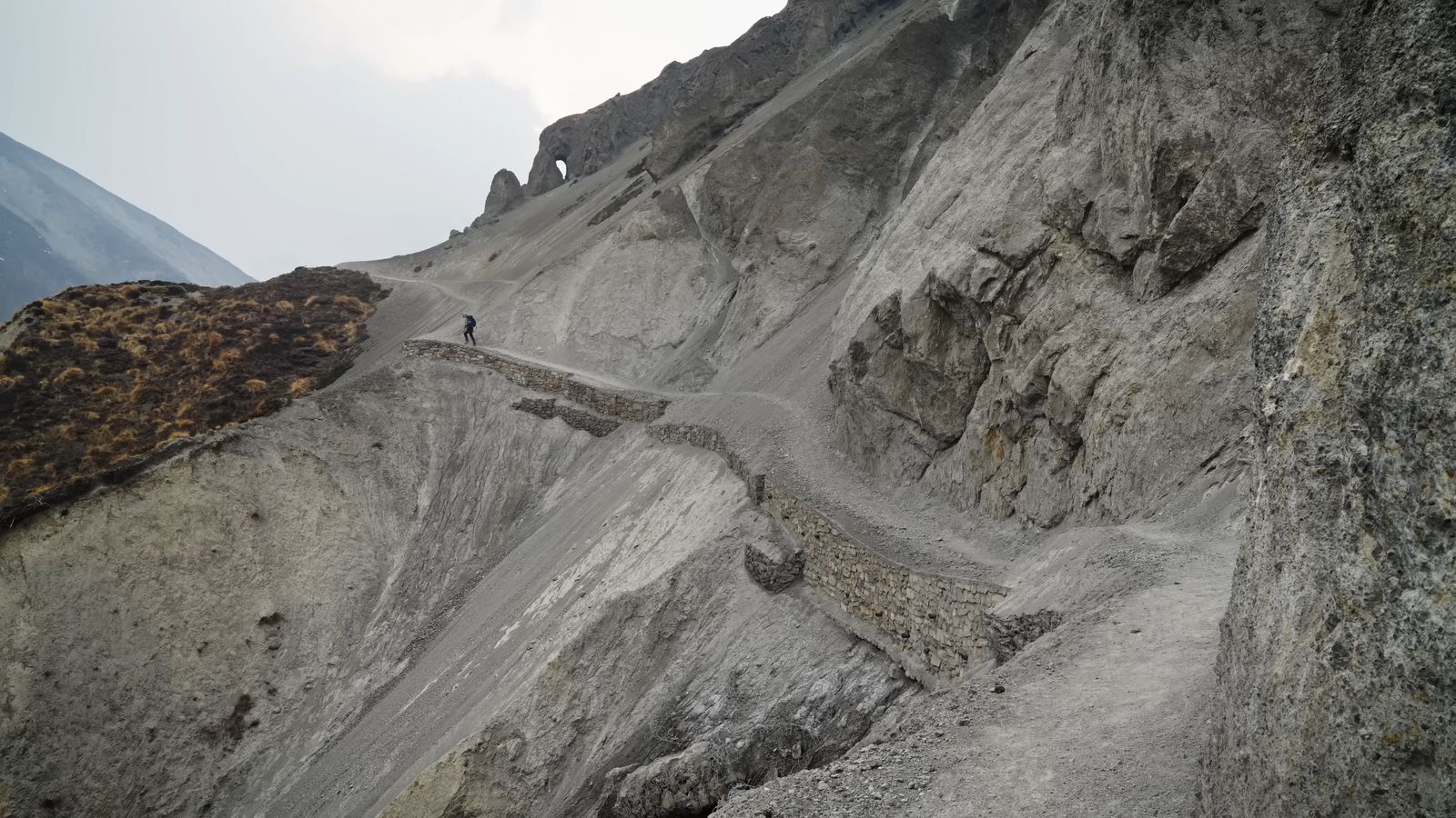 a person walking up a steep mountain side