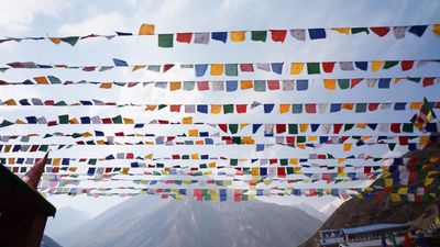 a bunch of colorful flags hanging in the air