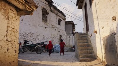 a couple of people that are walking down a street