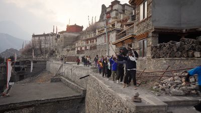 a group of people standing on the side of a road