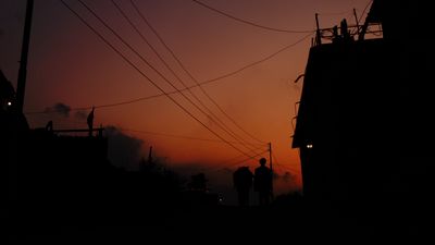 a couple of people that are standing in the dark