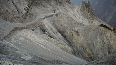 a man riding a snowboard down the side of a mountain