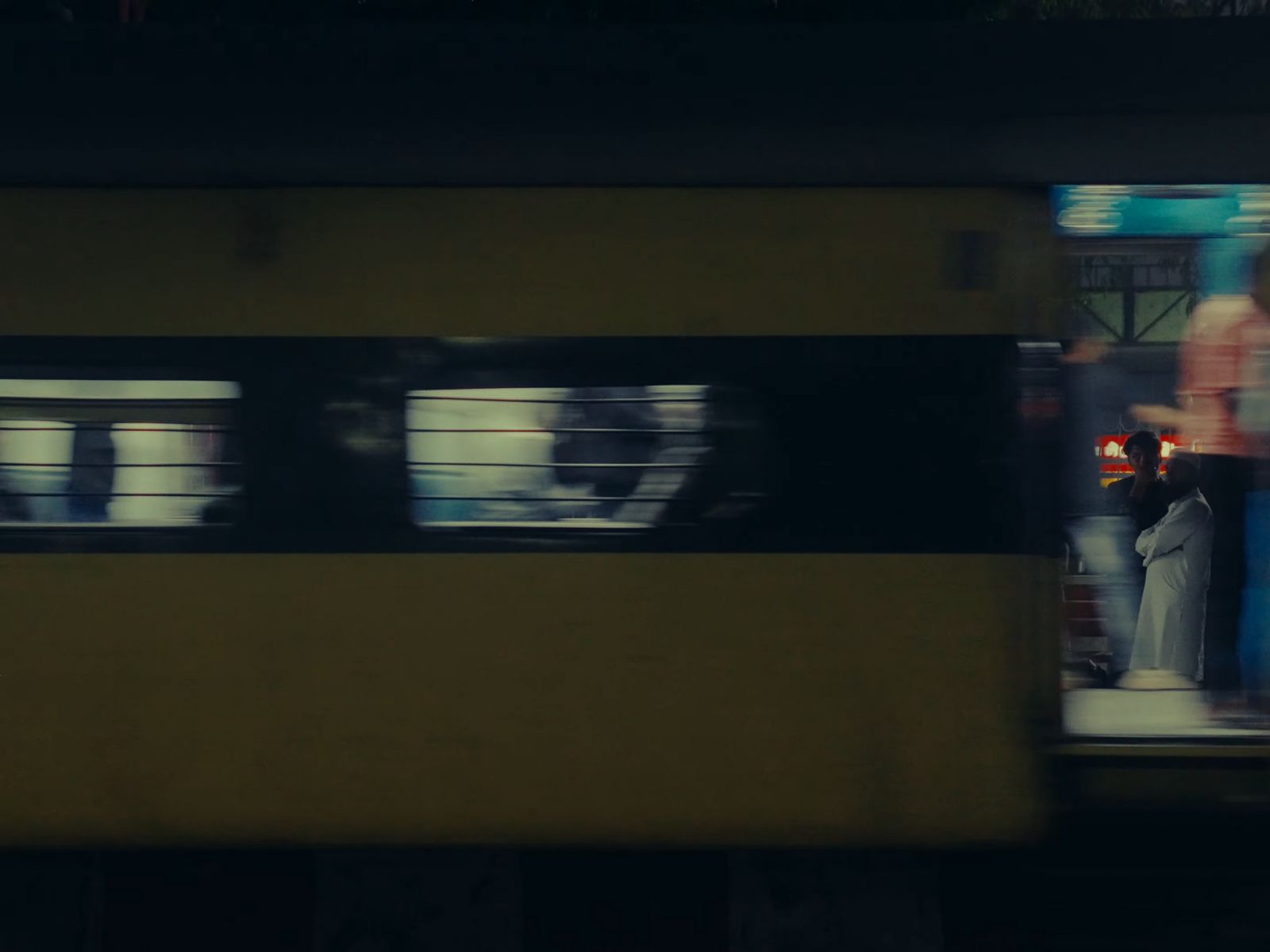 a man standing on a train platform next to a window