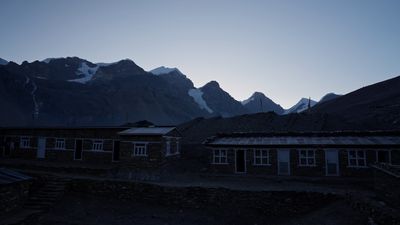 a building with a mountain in the background