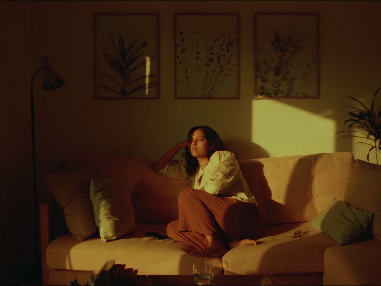 a woman sitting on a couch in a living room