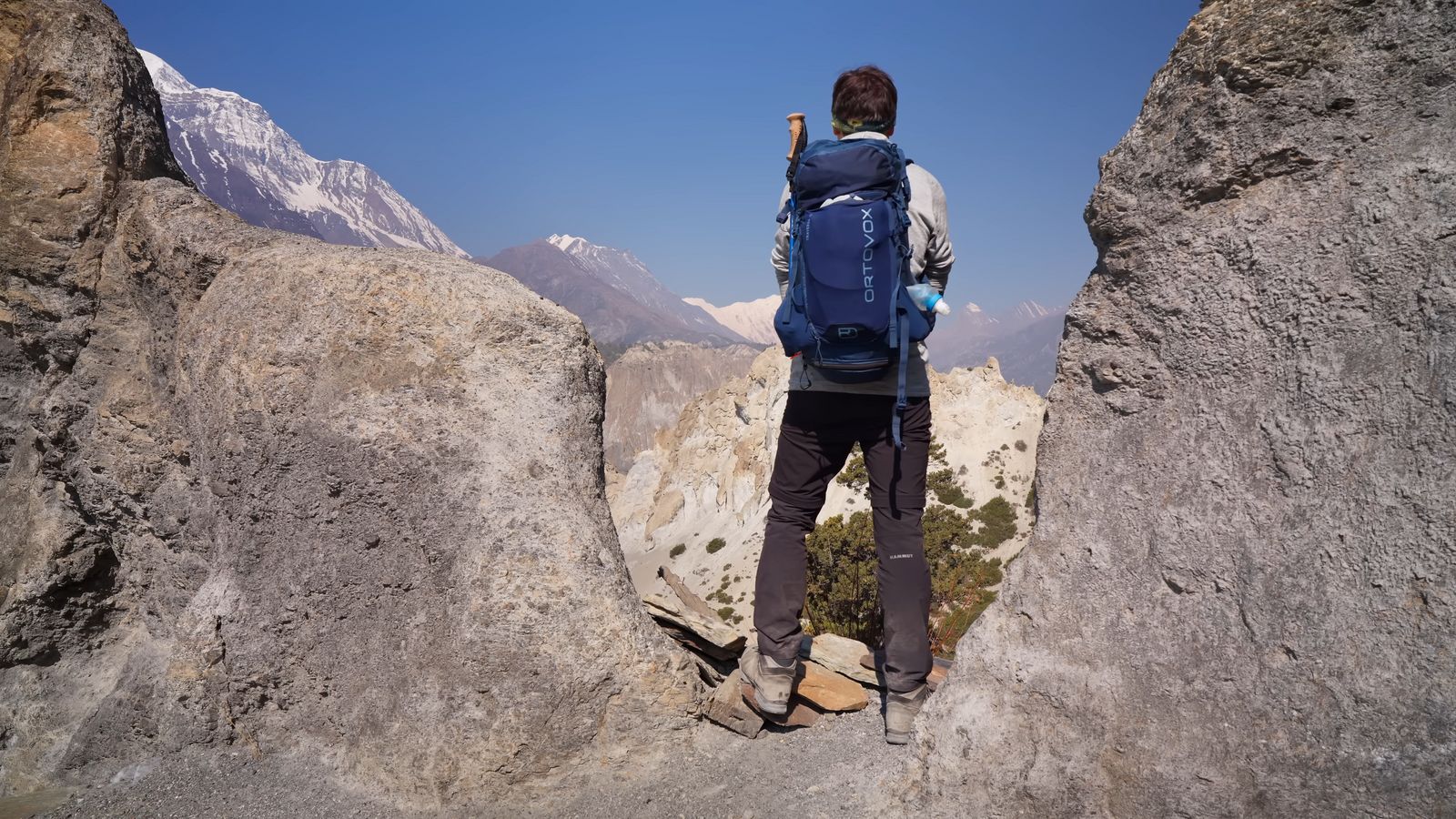 a person standing on top of a large rock