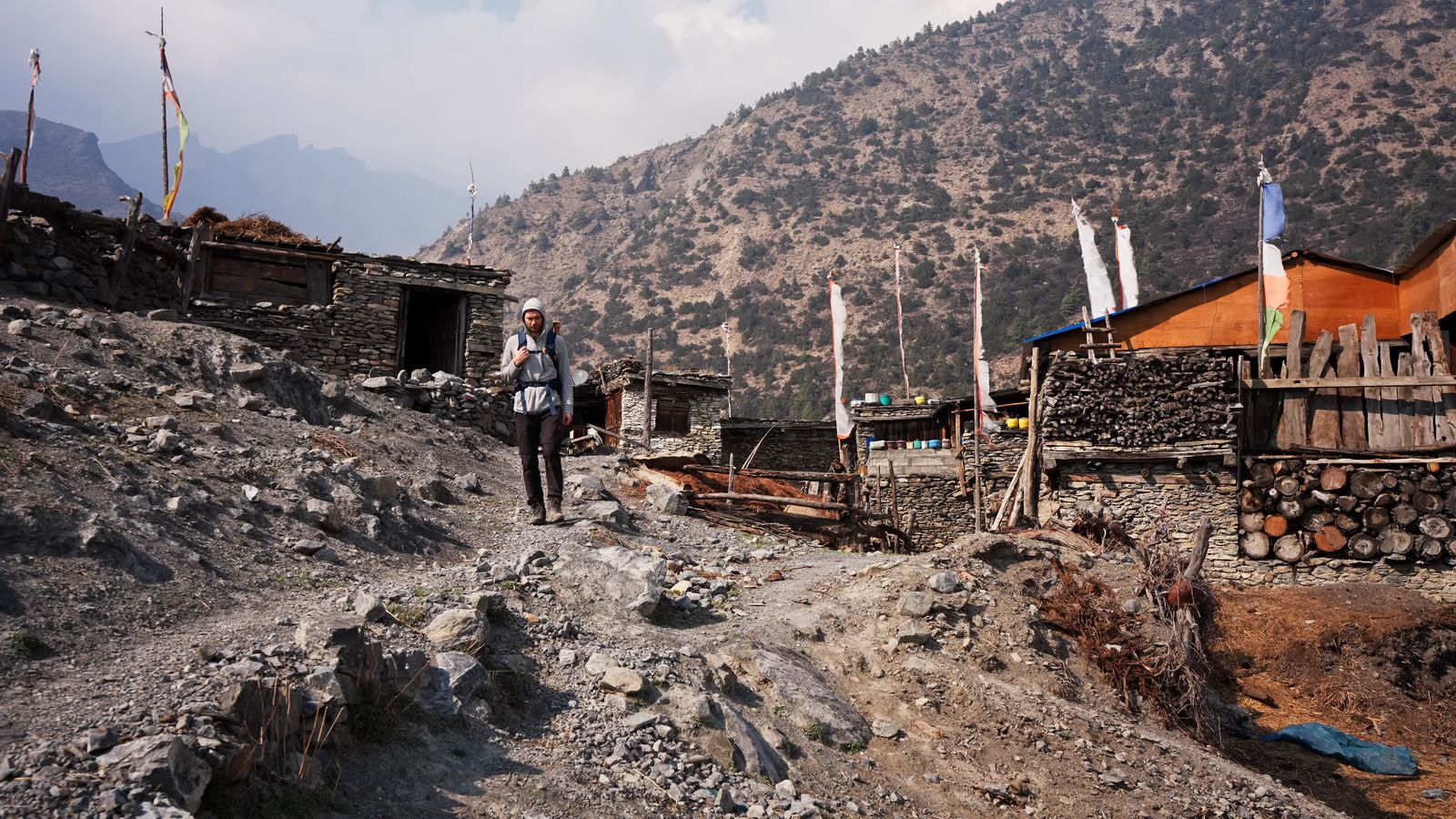 a man with a backpack walking up a hill