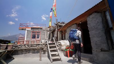 a man with a backpack walking up a set of stairs