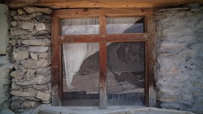 a window in a stone building with a rock wall