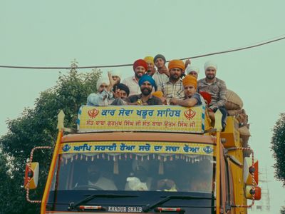 a group of people riding on top of a bus