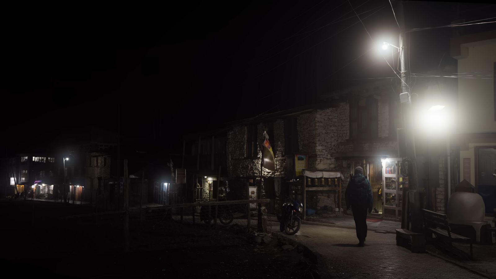 a man walking down a street at night