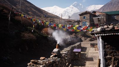 a small village with a mountain in the background