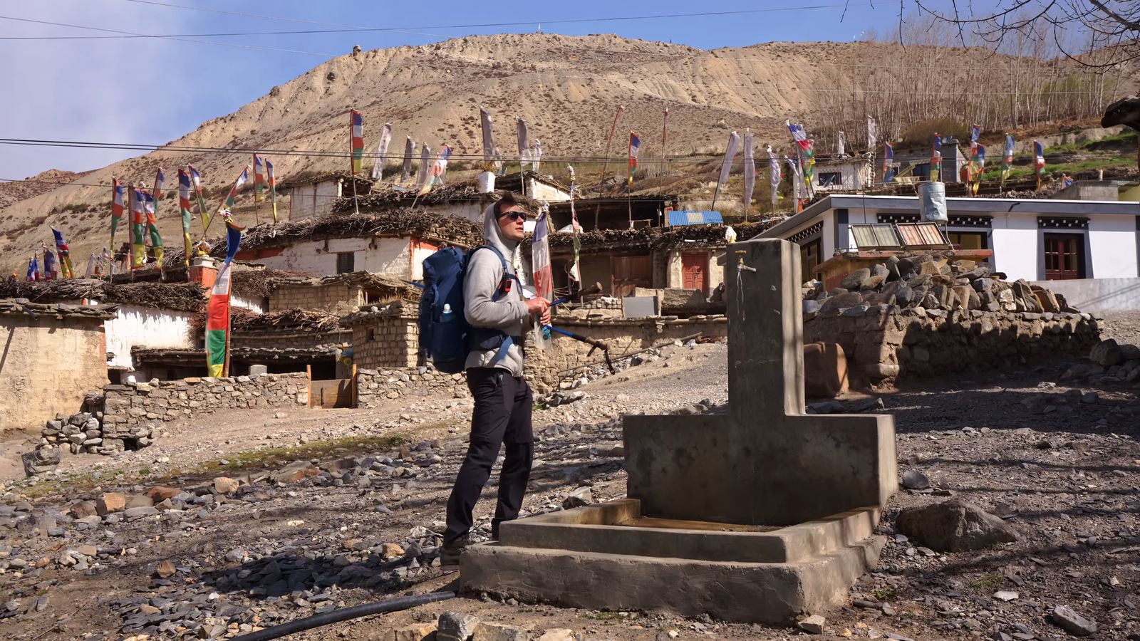 a man with a backpack standing in front of a building