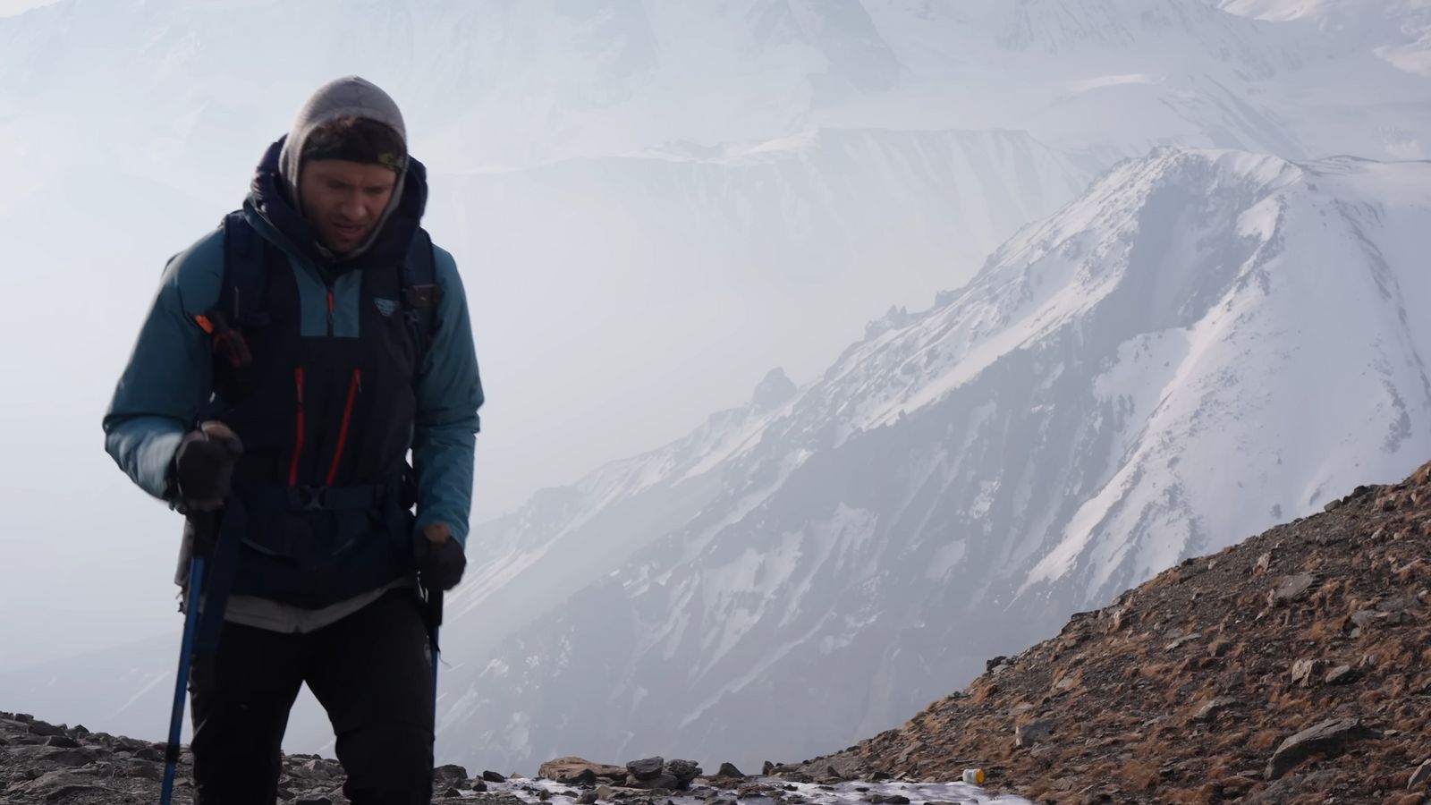 a man standing on top of a snow covered mountain