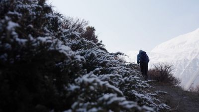 a person standing on a snow covered hill