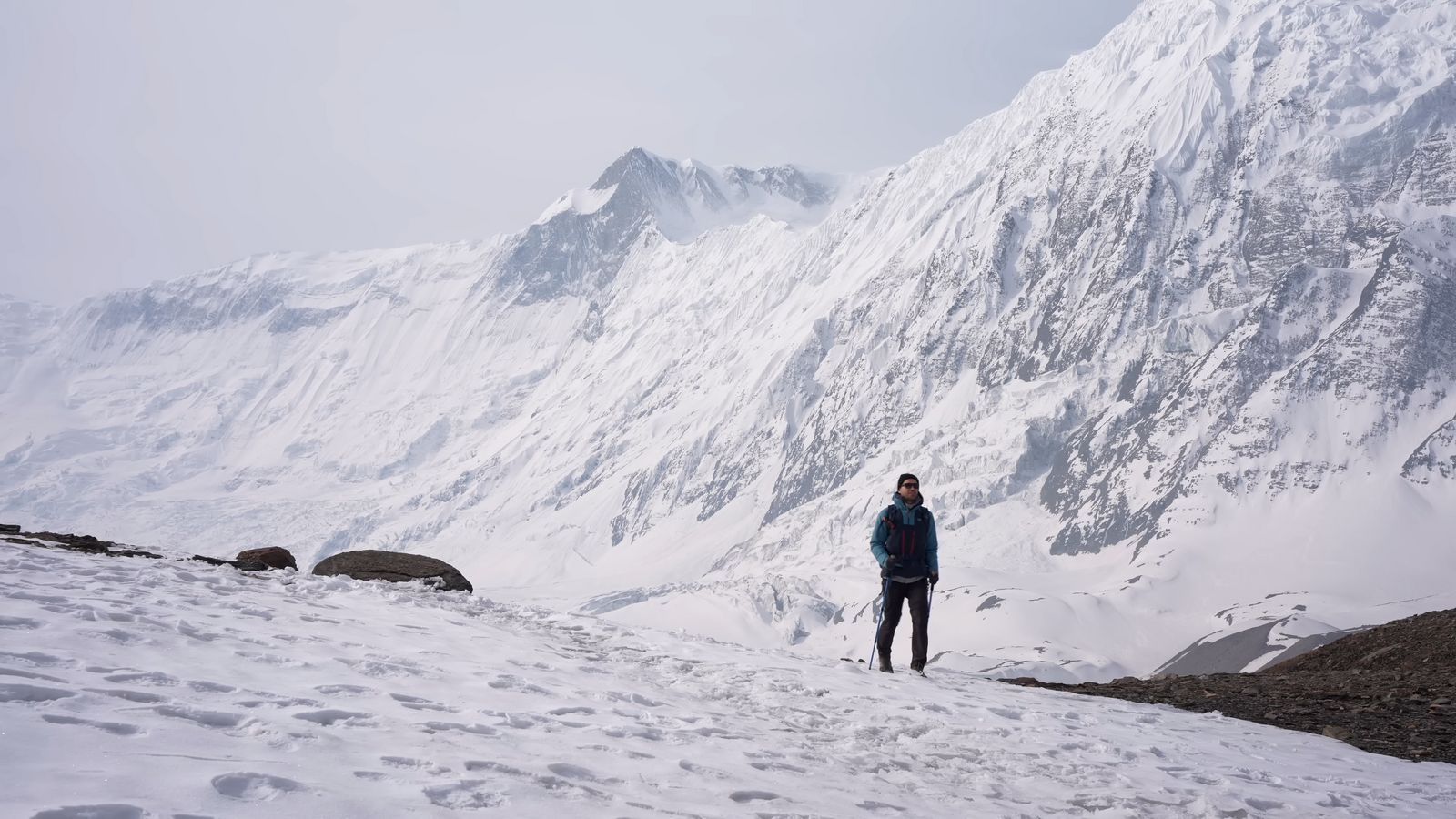 a man standing on top of a snow covered mountain