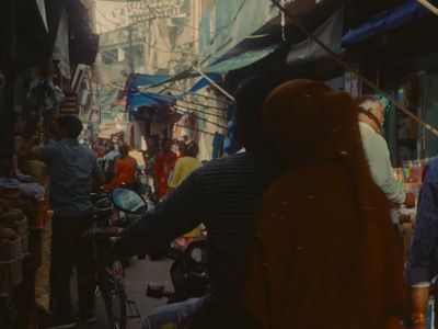 a man riding a bike down a street next to a crowd of people