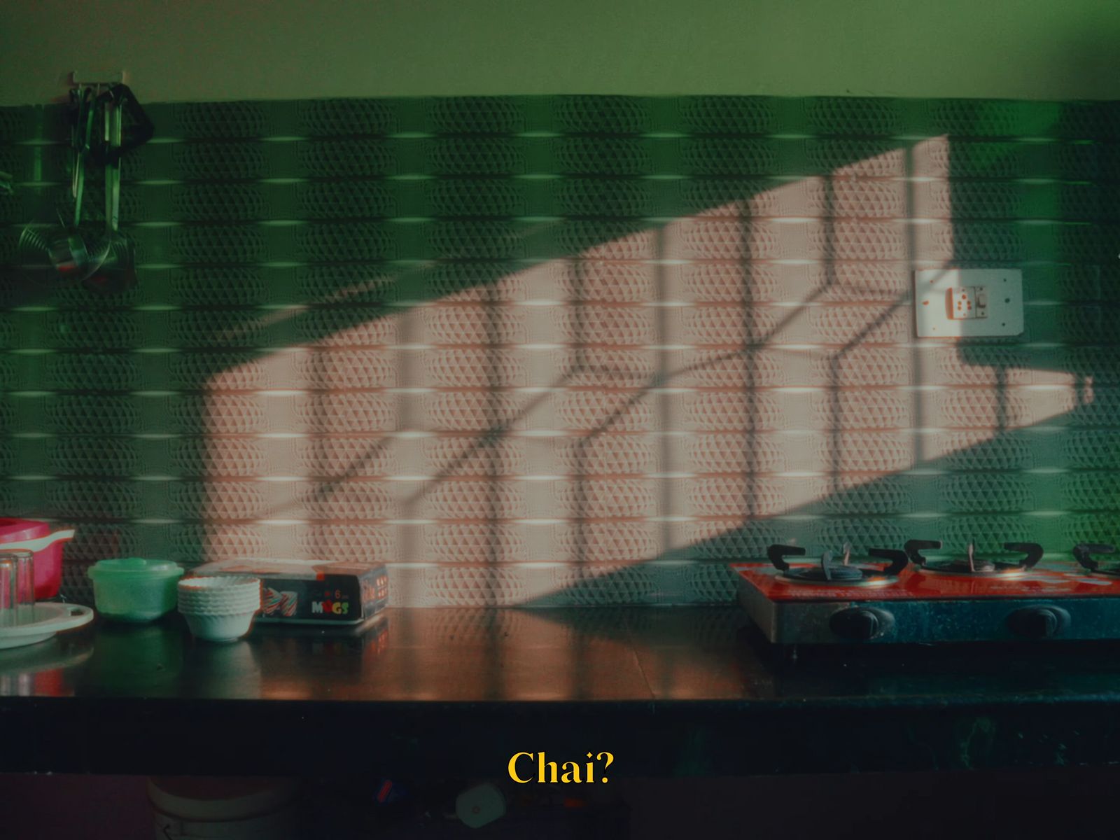 a stove top oven sitting next to a green wall