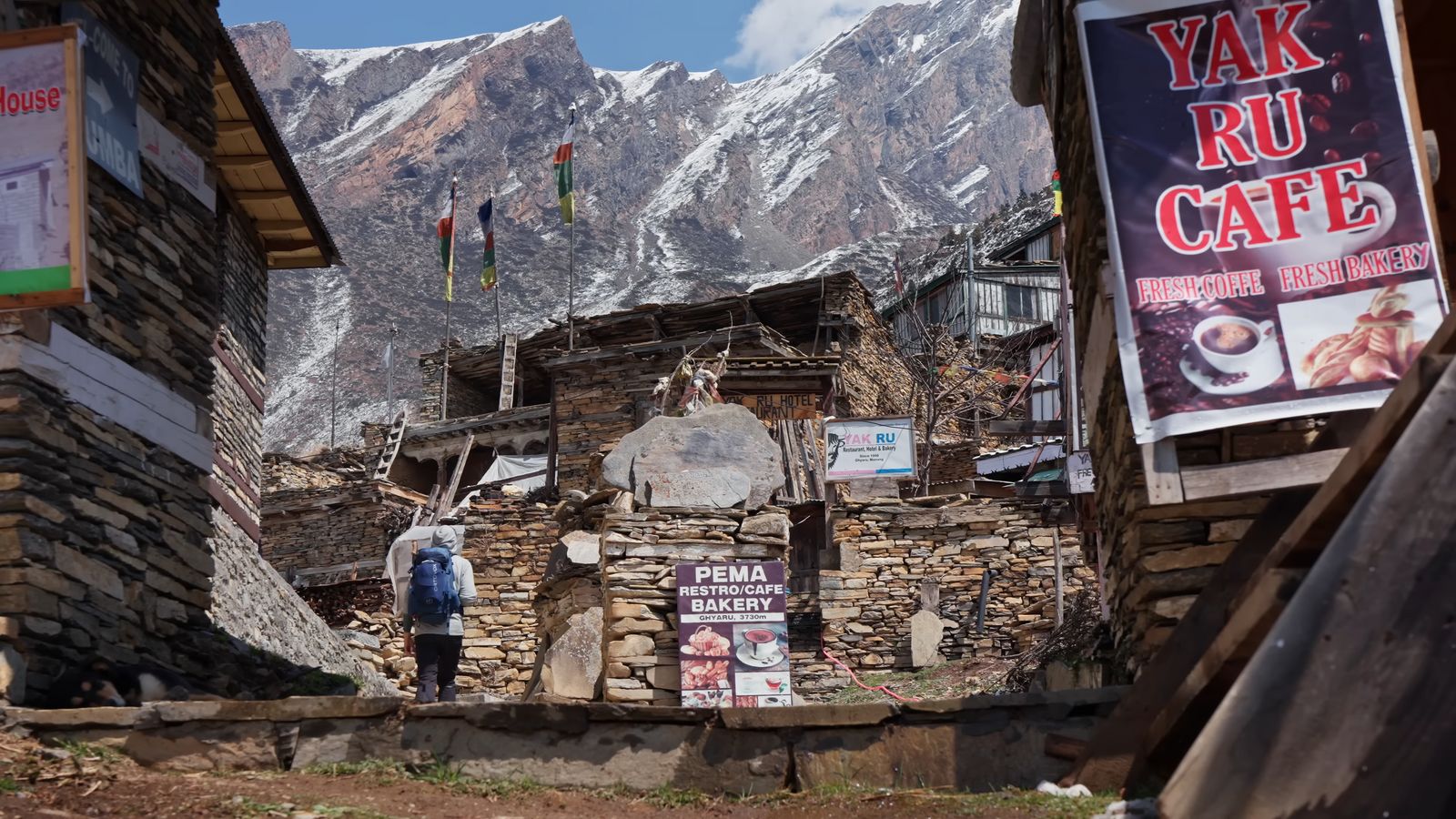 a man standing in front of a stone building