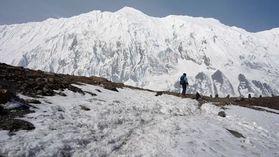 a man standing on top of a snow covered mountain