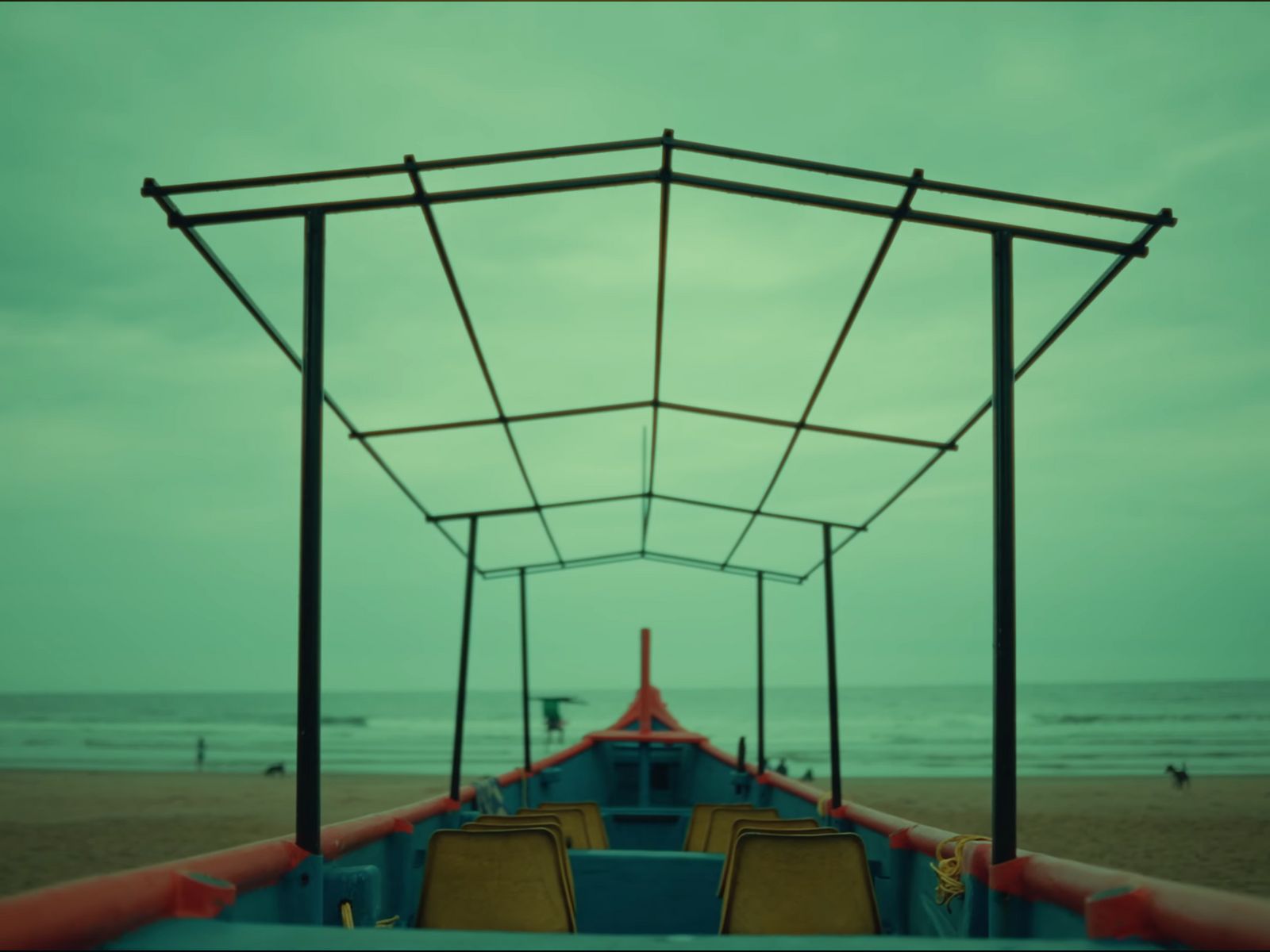 a boat sitting on top of a sandy beach