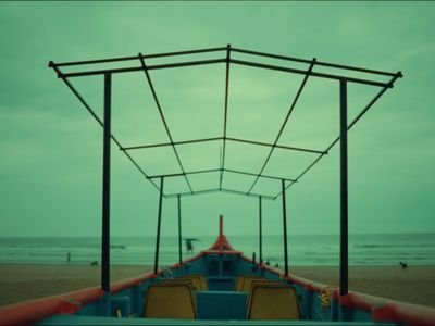 a boat sitting on top of a sandy beach