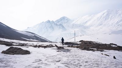 a man standing on top of a snow covered mountain