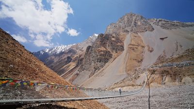 a suspension bridge in the middle of a mountain range