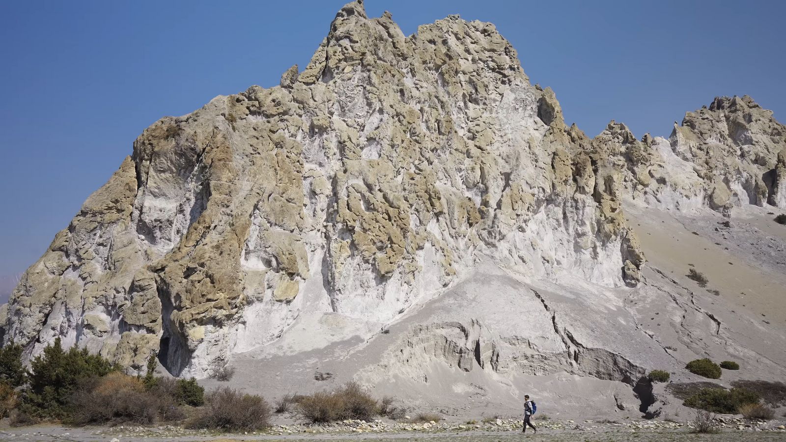 a person standing in front of a mountain