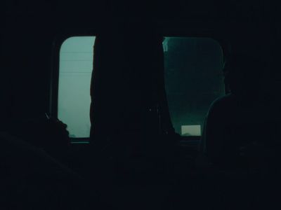 a person sitting in a bus looking out the window