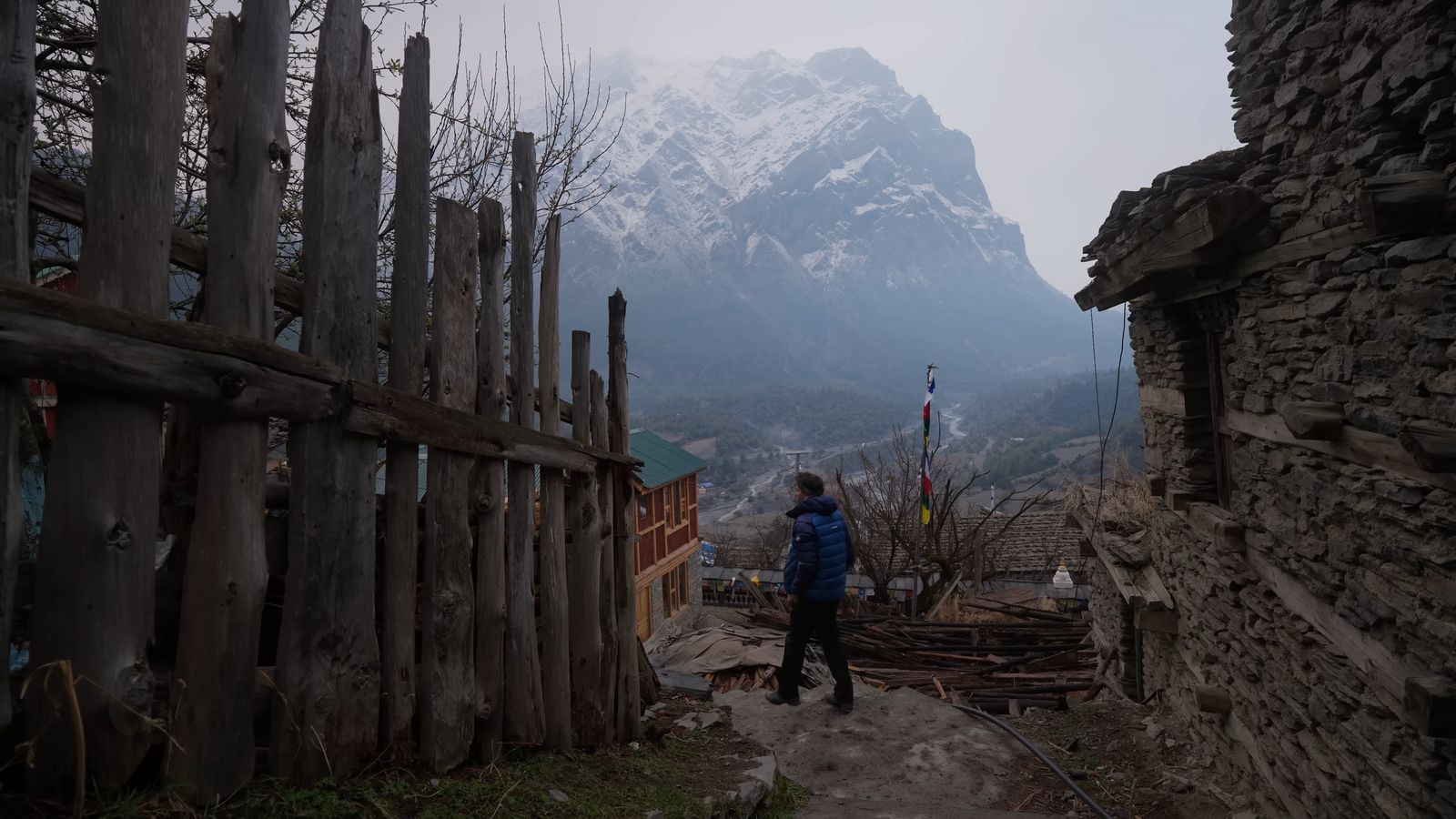 a person standing on a path in front of a mountain