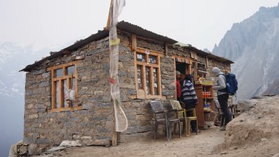 a group of people standing outside of a stone building