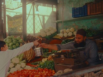 a man and a boy are shopping at a market