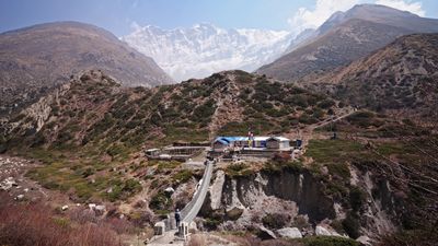 a view of a mountain range with a bridge going over it