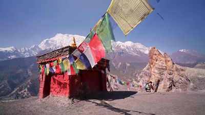 a small building with a lot of flags on top of it