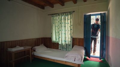 a bedroom with a bed and a window