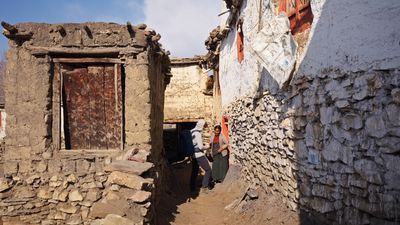 two people walking down a narrow alley way