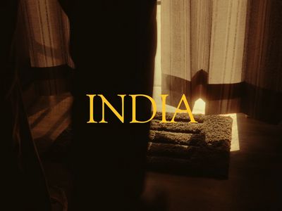 a person standing in front of a window with the word india on it