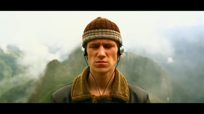 a man wearing headphones and a scarf