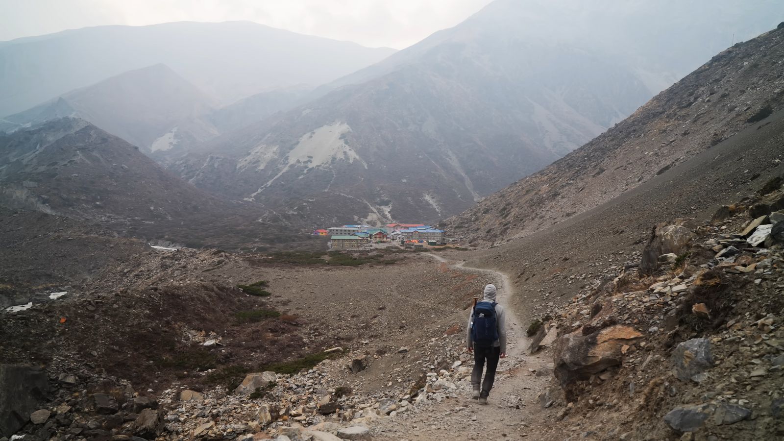 a person hiking up a mountain trail in the mountains