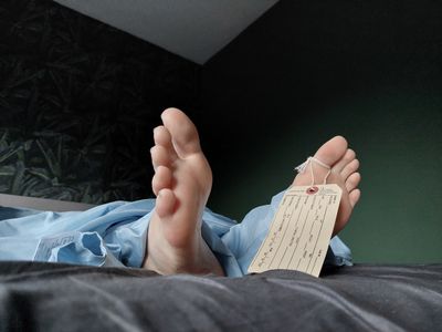 a person laying on a bed with their feet up